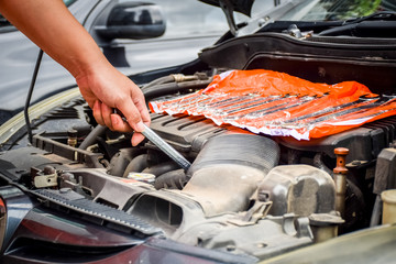 Man with checking car engine.