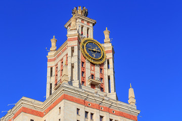 Tower with thermometer of Lomonosov Moscow State University (MSU) against blue sky in sunny summer evening