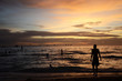 © peacefoo - Sunset time at a beautiful island with orange gradient colour of sky and people playing around the beach.