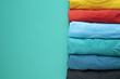 close up of rolled colorful clothes on green background