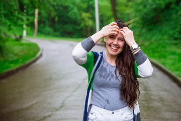 Poster - portrait of young adult woman wet after rain. smiling