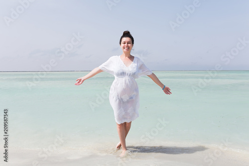 Young Pregnant Woman In White Dress Standing On The Beach Near Blue Sea And Breething Summer Vacation During Pregnancy Happy Motherhood Concept Stock Photo Adobe Stock