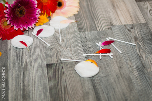 Cotton sponges with flowers on a background. Skin care and beauty Poster