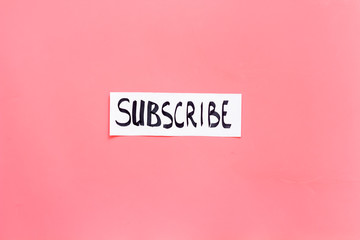 Poster - Subscribe template or mockup. Hand lettering subcribe on pink background top view space for text