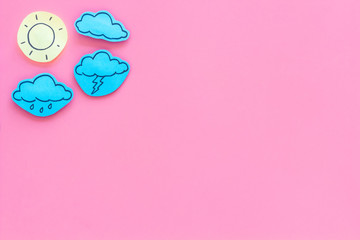 Wall Mural - weather forecast concept. modern weather icons set on pink background top view copy space