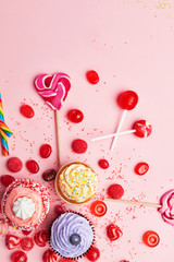 Wall Mural - Sweets. Candy And Cupcakes On Pink Background