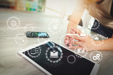 Poster - top view of Designer hand working with digital tablet computer on wooden desk as responsive web design concept