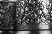 Details Of An Old Metal Cup Holders, Decorated With A Bas-relief Depicting Leaves, Cherries And Raspberries