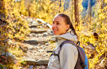 Wall Mural - Tourist hiking in aspen grove at autumn