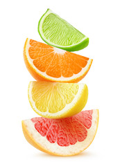 Canvas Print - Isolated citrus slices. Pieces of grapefruit, orange, lemon and lime fruits on top of each other isolated on white background with clipping path