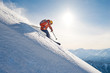 skier rides freeride on powder snow down slope against the backdrop of the mountains