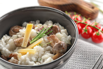 Sticker - Bowl with risotto and mushrooms on table, closeup