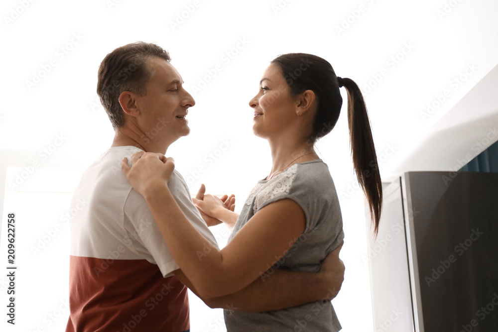Lovely couple dancing together at home