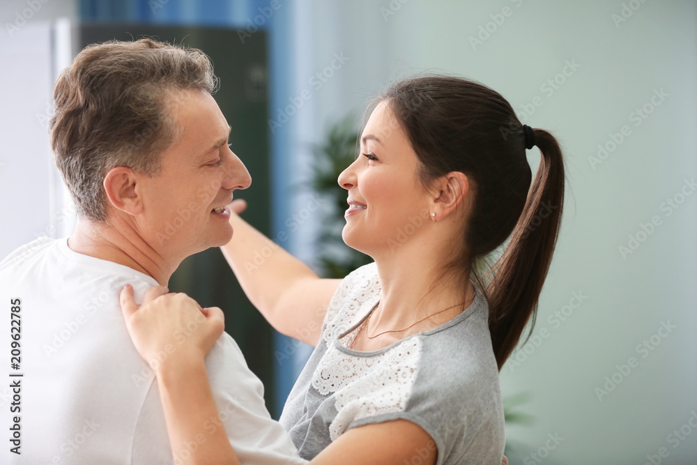 Lovely couple dancing together at home