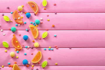 Wall Mural - Colorful chewy candies on wooden background