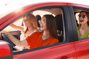 Happy beautiful young women together in car