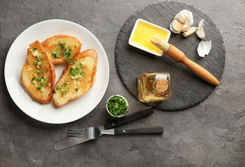 Poster - Plate with delicious homemade garlic bread on table