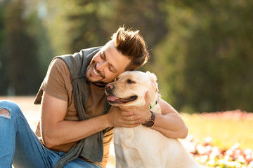 Poster - Cute yellow labrador retriever with owner outdoors