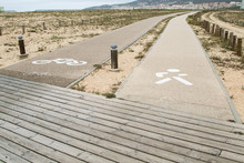 Parallel Paths On A Beach Marked For Pedestrians And Bicyclists.