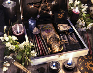 Poster - Witch box with black candles, tarot cards, runes, voodoo doll and magic objects with flowers Occult, esoteric and divination still life. Halloween background with vintage objects and magic ritual