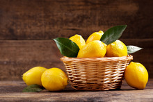 Fresh Lemons With Leaves In A Basket