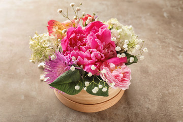 Gift box with beautiful flowers on table