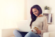© guerrieroale - happy woman using laptop and buying online with credit card