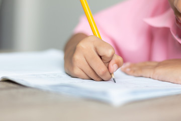 Close up a little girl doing homework