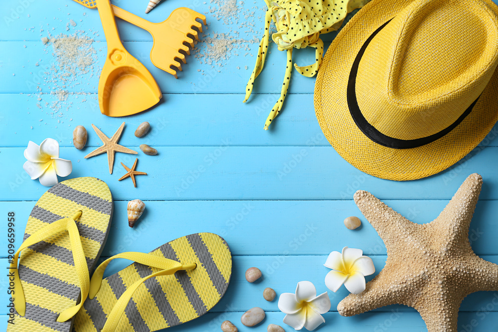 Composition with beach accessories on color wooden background