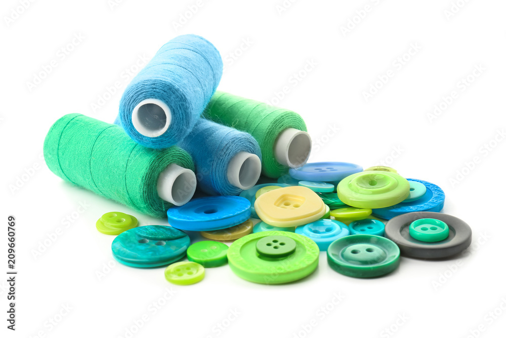 Color sewing threads with buttons on white background
