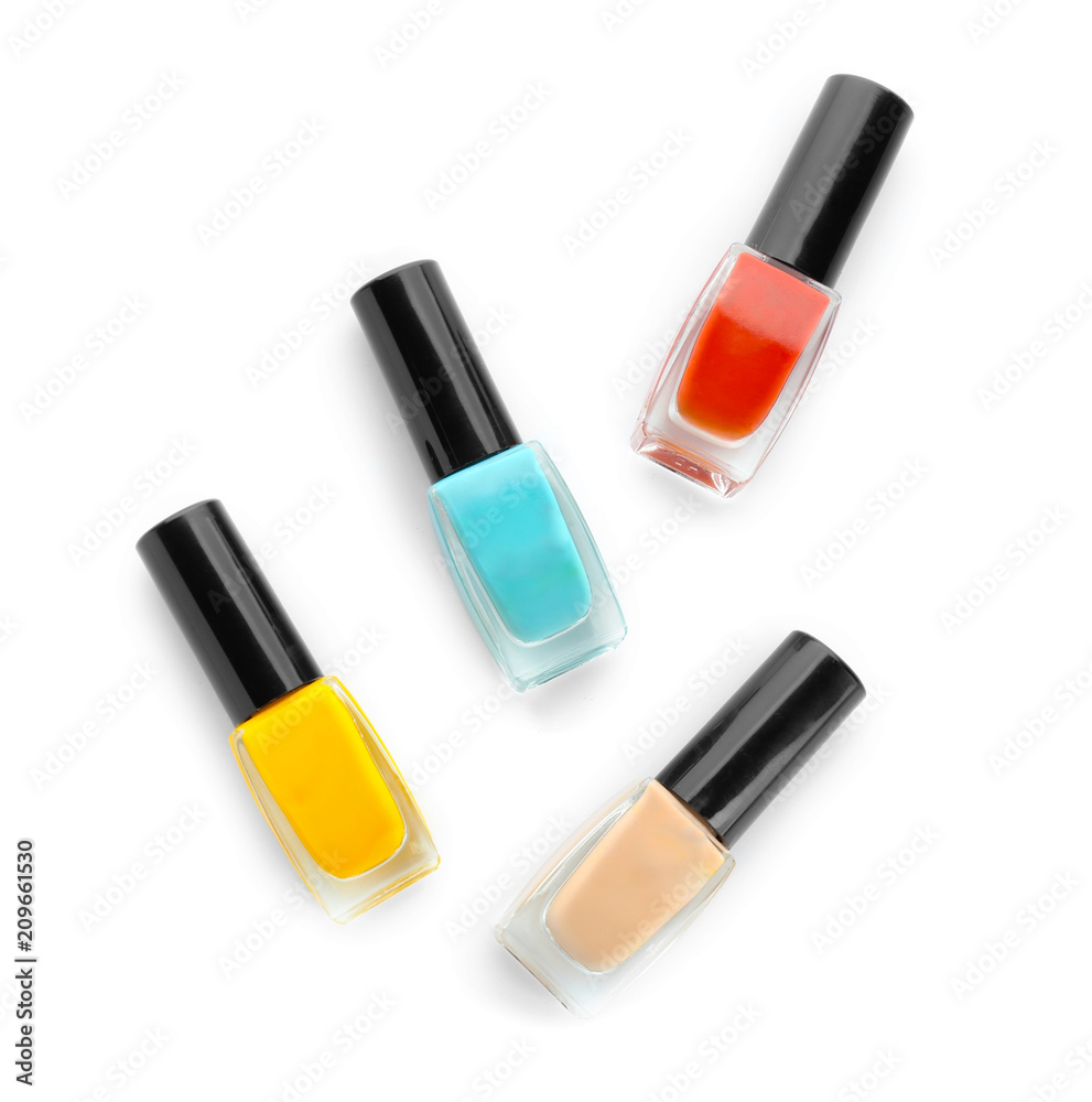 Bottles of colorful nail polish on white background
