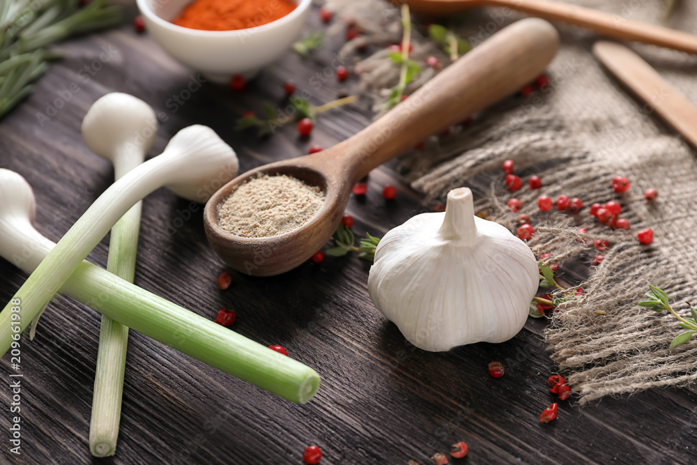 Various spices with vegetables on wooden table