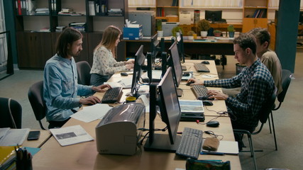 Young Casual Teamwork is Working at the Computers in the Busy Office