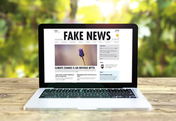 Poster - laptop wih fake news software on table