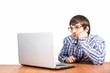 © maximbolshakov - sad guy with glasses sitting at table with computer computer