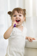 © Oksana Kuzmina - Cute little child girl brushing teeth in bathroom