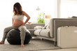 Pregnant woman doing relax exercises with a fitball