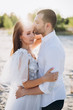 © LIGHTFIELD STUDIOS - beautiful happy couple embracing on beach with back light