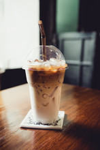Iced Latte With Straw In Plastic Cup On Wood Table In Coffee Shop,cafe Leisure Lifestyle.