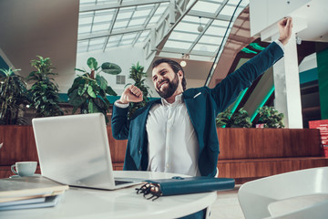 Wall Mural - Worker man exercising stretching arms in office.