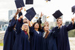 © Syda Productions - education, graduation and people concept - group of happy international students in bachelor gowns throwing mortar boards up in the air