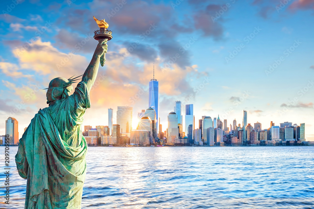 Statue Liberty and  New York city skyline at sunset - obrazy, fototapety, plakaty 