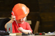 © be free - Boy play as builder or repairer, work with tools. Child dreaming about future career in architecture or building. Childhood concept. Kid boy in orange hard hat or helmet, study room background.
