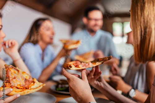 Fotografía Eating pizza with friends. Close-up.