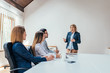 © bnenin - Businesswoman presenting to colleagues at a meeting. Copy space.
