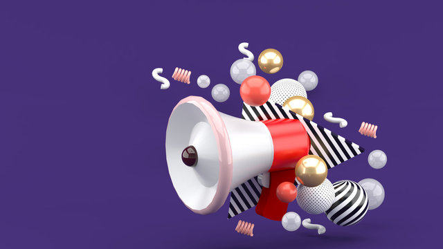 Red megaphone among colorful balls on purple background.-3d rendering.