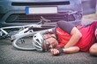 © Monika Wisniewska - Cyclist lying on the road after hitting by a car