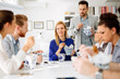 © NDABCREATIVITY - Business people eating in office