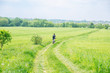 © phpetrunina14 - man riding bicycle by trail in green barley field. copy space
