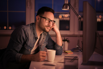 Man working on computer late at night